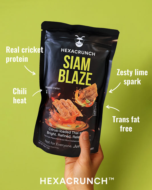 Hexacrunch Siam Blaze snack package held by a hand on a green background