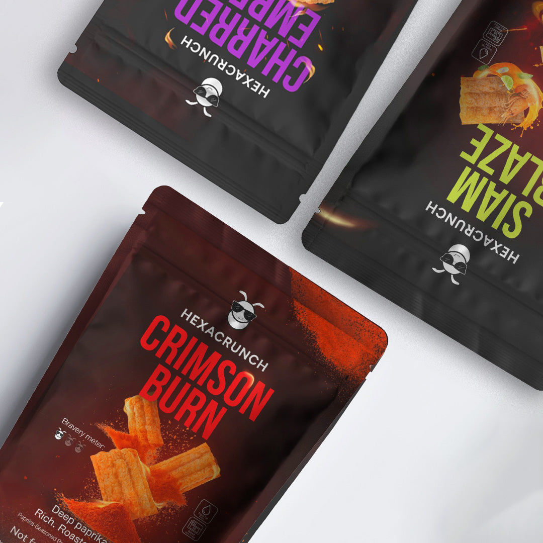 HexaCrunch cricket protein snacks – Charred Ember BBQ, Siam Blaze Tom Yum, and Crimson Burn Paprika flavours in premium black pouches.