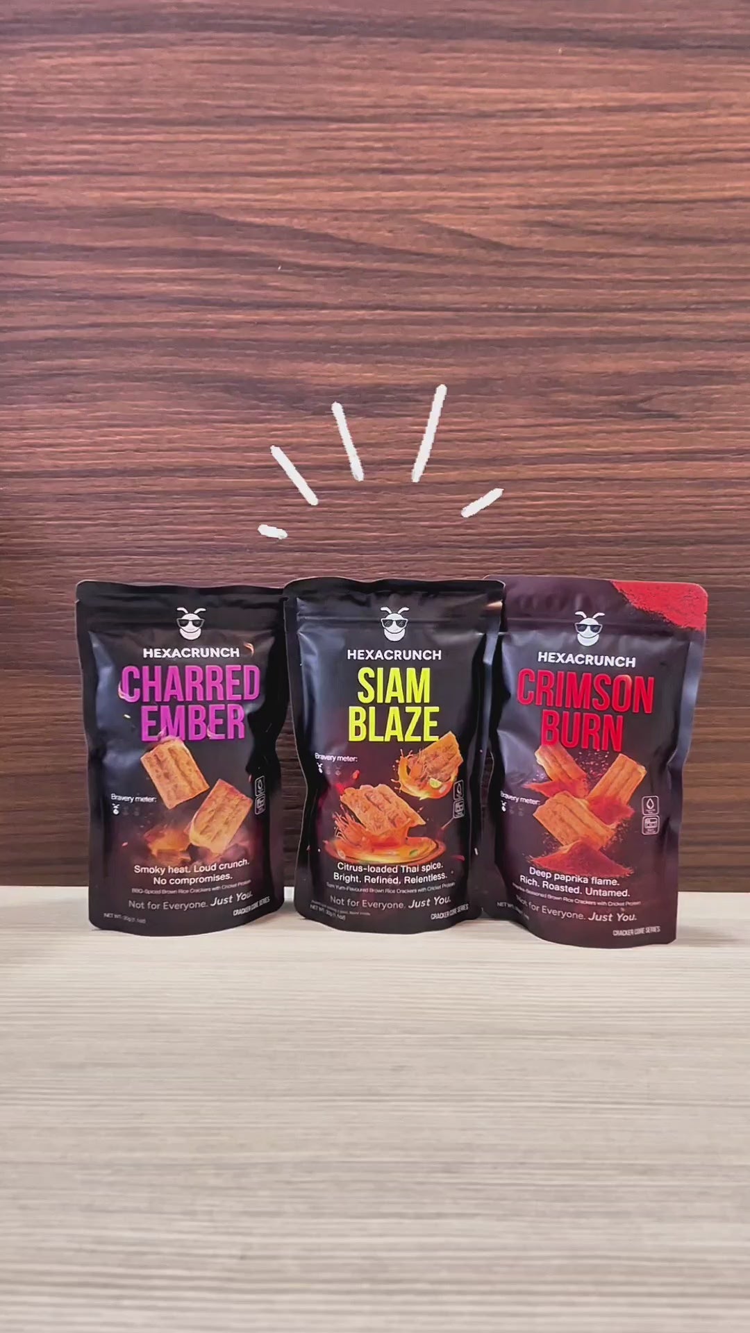 HexaCrunch premium insect-protein crackers shown in a hero shot with three upright packs, followed by close-up pans of the packaging and protein details, ending with a product reveal of the baked crackers being poured into a bowl and shown in crisp, textured close-ups.