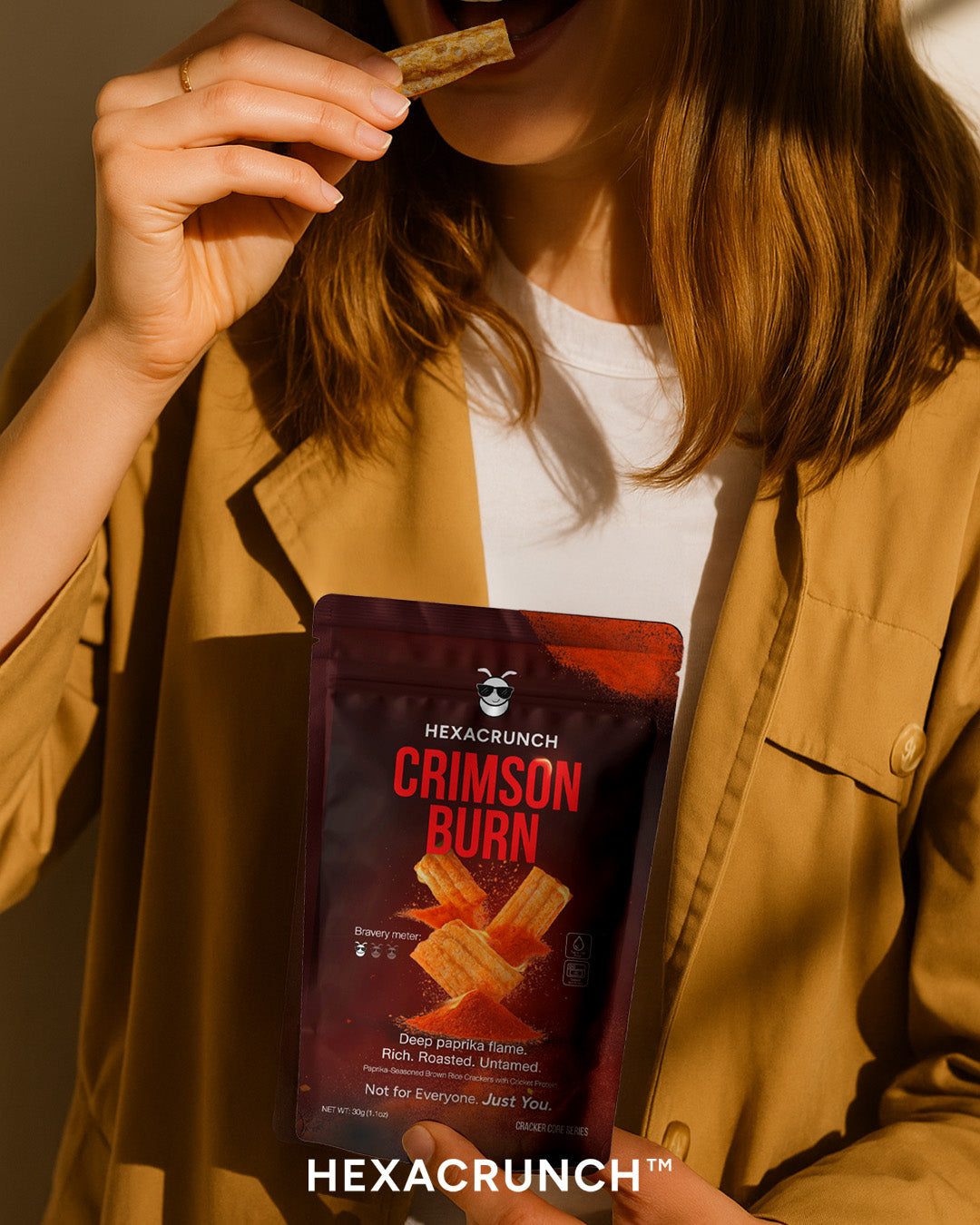 Person holding a HEXACRUNCH Crimson Burn snack package
